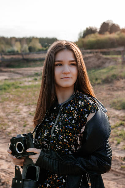 istock Girl holding a camera without a lens. 1225611884