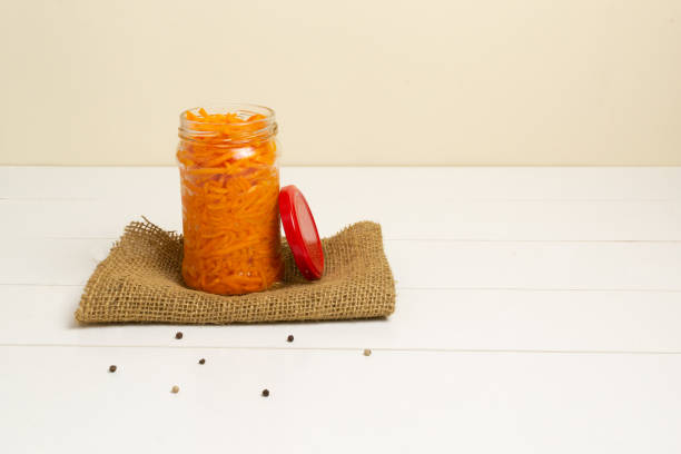istock Fermented carrots with spices in a glass jar. Horizontal orientation. Copy space. 1225612898