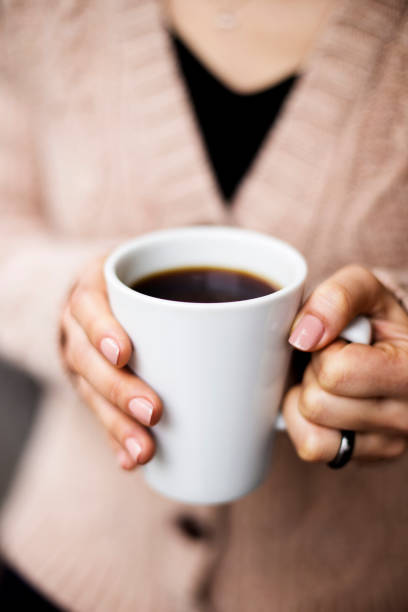 istock Coffee Cup, Lady's hands holding Coffee Cup, Woman holding a white mug 1225613032