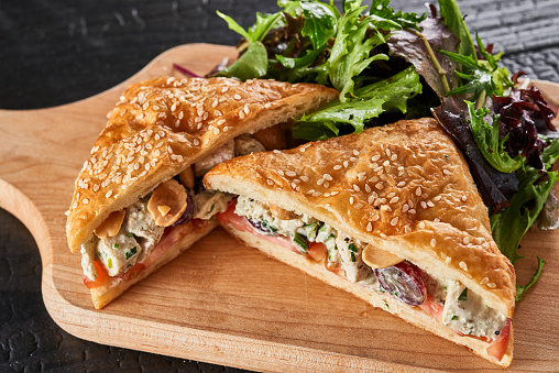 Baked hearty puff pastry sticks with ham and herbs
