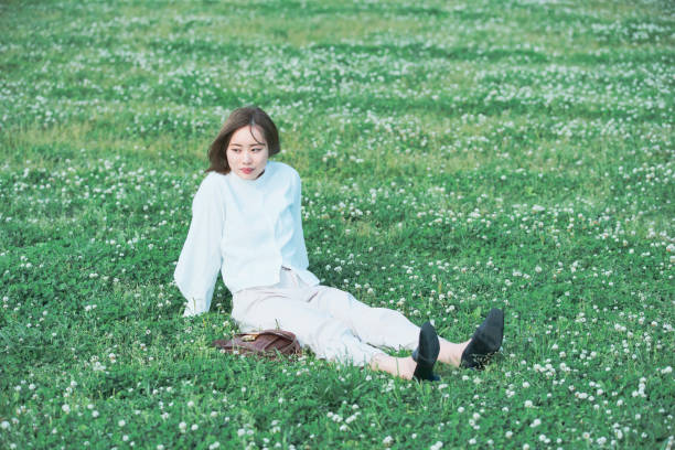 istock Asian young woman on the meadow 1225618921