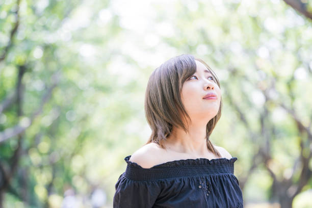 istock Asian young woman walking in the park 1225618977
