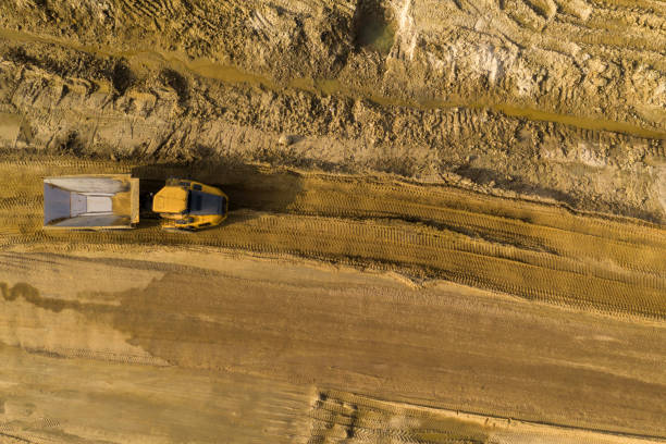 istock Big yellow excavator at a road construction site 1225619955