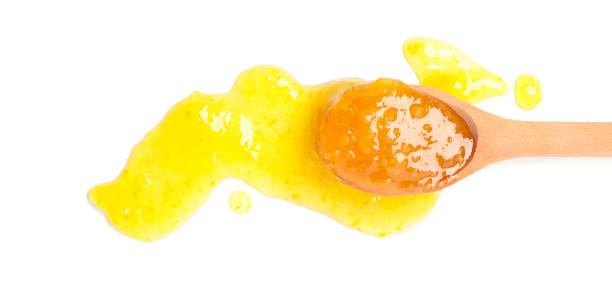 istock Spoon with apricot jam isolated on white background 1225620229
