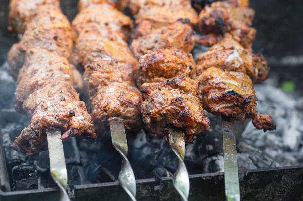 istock Cooking shashlik. Grilling pork on coal 1225623364