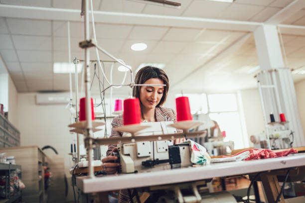 istock Dressmaker woman working with sewing machine 1225623696