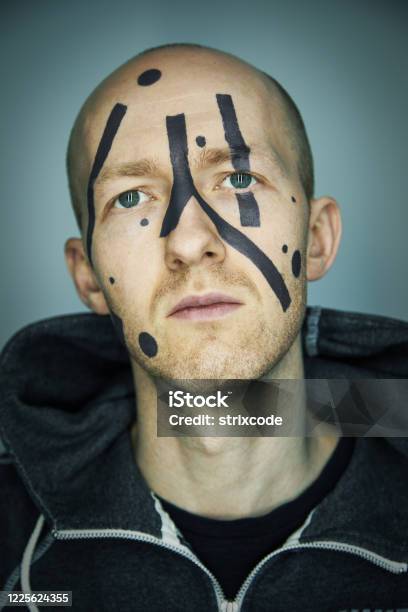 Close Up Portrait Of Man Hiding His Face From Camera Recognition With Special Camouflage Makeup Digital Privacy In Big City Concept Image Stock Photo - Download Image Now
