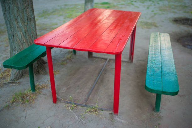 istock Red painted wooden table in the yard 1225625115