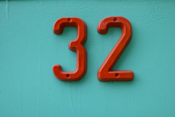 istock House number 32 Red on a green iron front door 1225625225