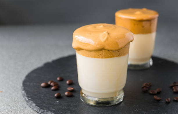 istock Dalgona coffee whipped cream mousse against grey background, also dubbed as quarantine drink 1225625238