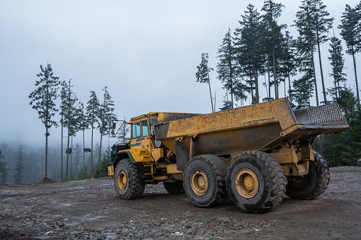 Dump truck at a construction site during the rain on Vancouver Island.