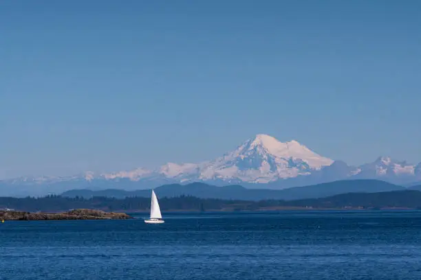 Sailboat with Mt.Baker in the distance as seen from Cattle Point in Victoria,BC.