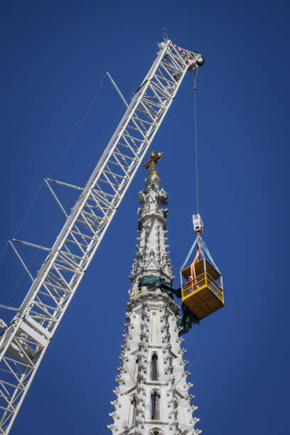 Workers with tall cranes fixing Zagreb Cathedral tower Zagreb, Croatia - April 15, 2020 : Workers with tall cranes are preparing to separate top of the Zagreb Cathedral tower that was damaged by the earthquake of 5.5 on the Richter scale one month ago. zagreb earthquake stock pictures, royalty-free photos & images