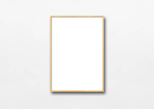Wooden picture frame hanging on a white wall Wooden picture frame hanging on a white wall. Blank mockup template isolated color photos stock pictures, royalty-free photos & images