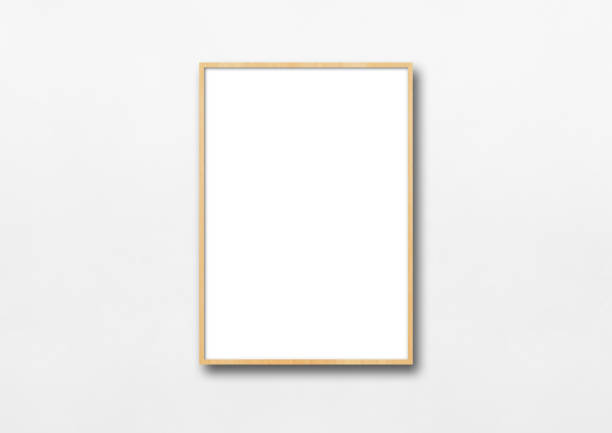 Wooden picture frame hanging on a white wall Wooden picture frame hanging on a white wall. Blank mockup template hanging art on wall stock pictures, royalty-free photos & images