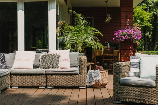 istock Garden patio decorated with Scandinavian wicker sofa and coffee table 1225630008