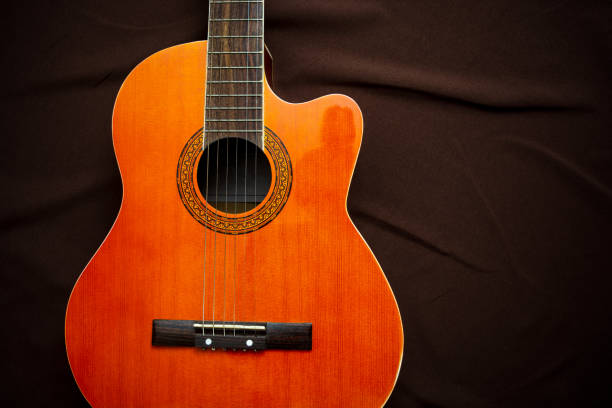 istock Six-string acoustic guitar on a dark brown background. Classical Spanish guitar. Musical instrument. 1225630323