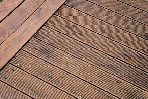 istock Natural outdoors wooden board floor. Brown floor fixed with screws pins. 1225631265