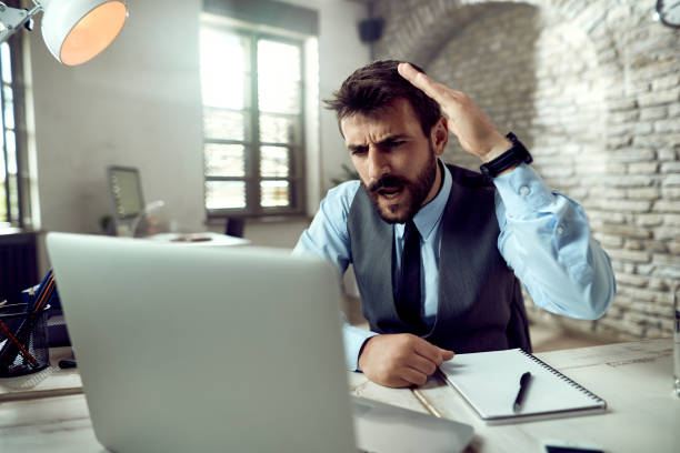 istock Angry businessman discussing with someone while having video conference over laptop. 1225632911