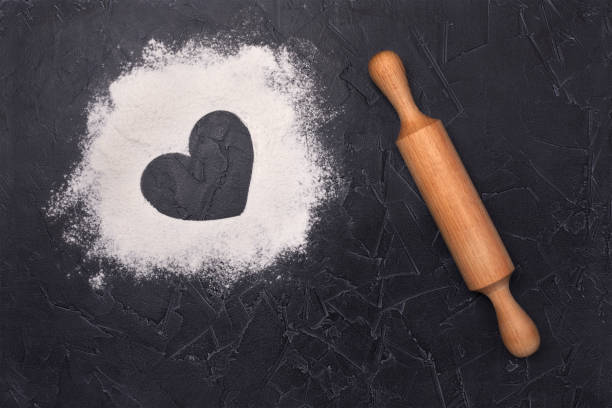 istock Scattered flour on the table and rolling pin. View from above. A heart. 1225633222