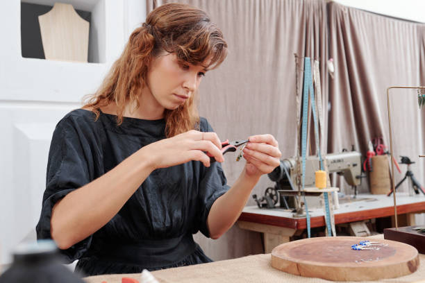 istock Young woman making earrings 1225633323