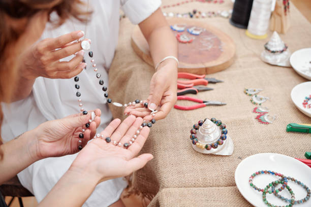 istock Women making jewelry at home 1225633465