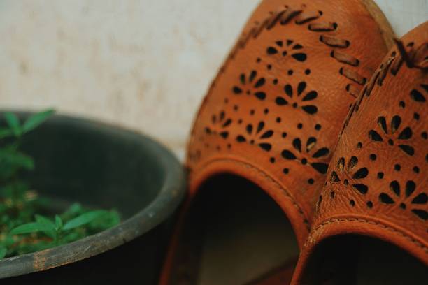 Traditional handmade items A handmade Chapels in Indian traditional style. handmade indian shoes on white stock pictures, royalty-free photos & images
