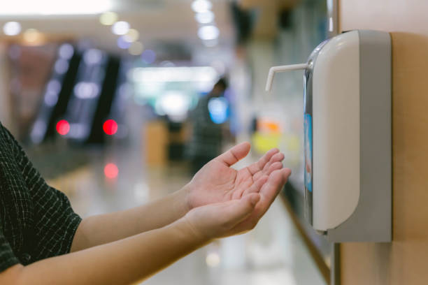 istock Hands under the automatic alcohol dispenser. Infection and hospitably concept. save and protect disease virus against germs and clean in the public area. 1225636215