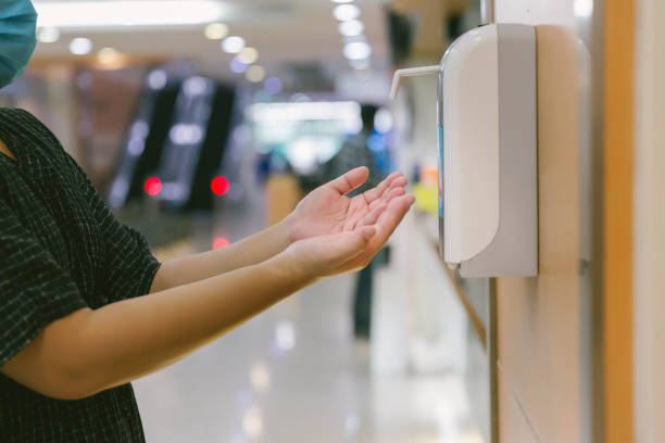 istock Hands under the automatic alcohol dispenser. Infection and hospitably concept. save and protect disease virus against germs and clean in the public area. 1225636252