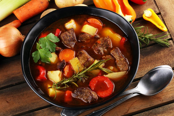 istock Meat stew with vegetables. Beef stew with potatoes, carrots and fresh herbs on table. 1225636293