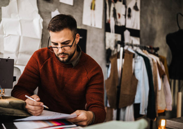istock Male tailor sketching in clothing design studio 1225640544