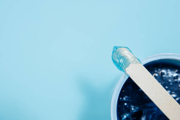 istock Blue soft wax lies on a depilation spatula. Sharpness is on wax with a spatula. 1225641376