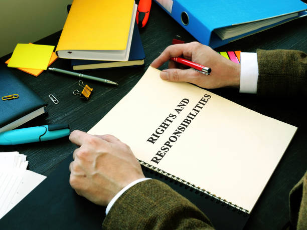istock Manager reads Employee rights and responsibilities list book. 1225644734