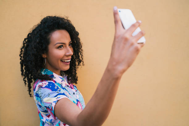 istock Afro woman taking selfies with phone. 1225647104