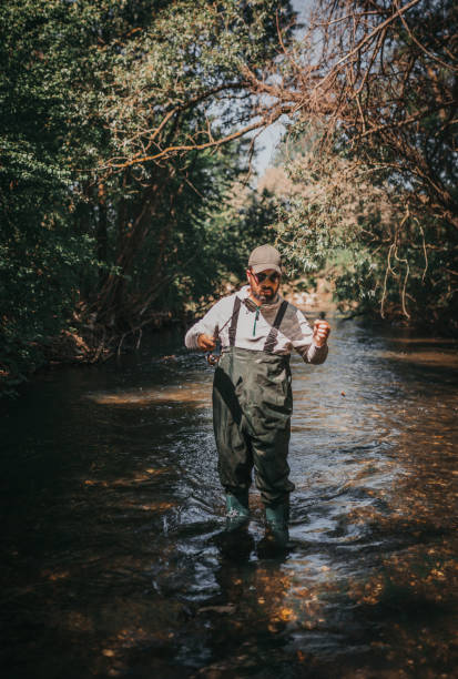 istock Fisherman holding a fishing rod 1225647623