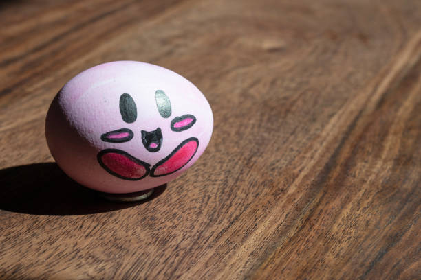 istock funny cartoon Easter egg in wooden background 1225651083
