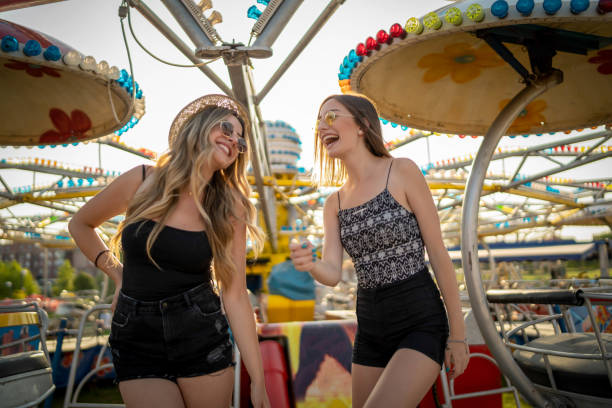 istock Happy girlfriends at the amusement park 1225652902