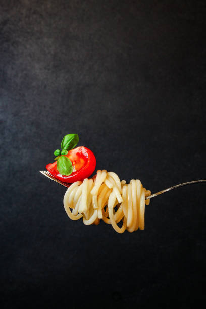 istock pasta spaghetti with tomato and basil, Menu concept healthy eating. food background top view copy space 1225653716