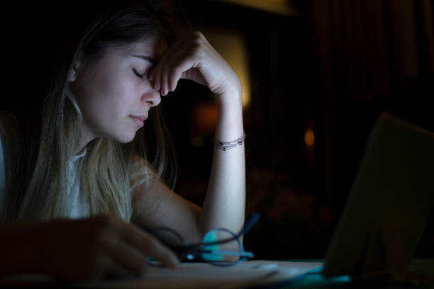 istock young business woman has a headache while working at night 1225654448