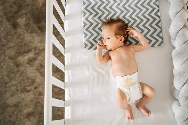 istock Newborn baby lying in his crib 1225655624