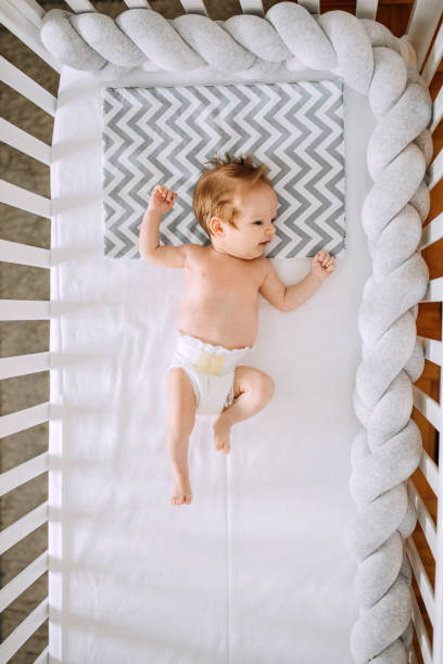 istock Newborn baby lying in his crib 1225655644