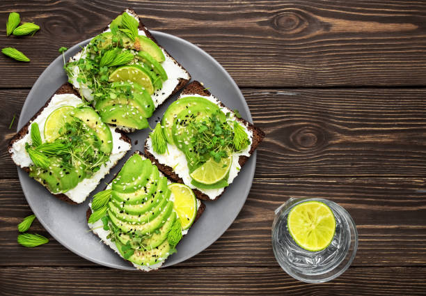 istock Sandwich with microgreens, cheese, avocado and spruce tips. Top view with copy space, tasty and healthy vegetarian breakfast, copy space 1225655698