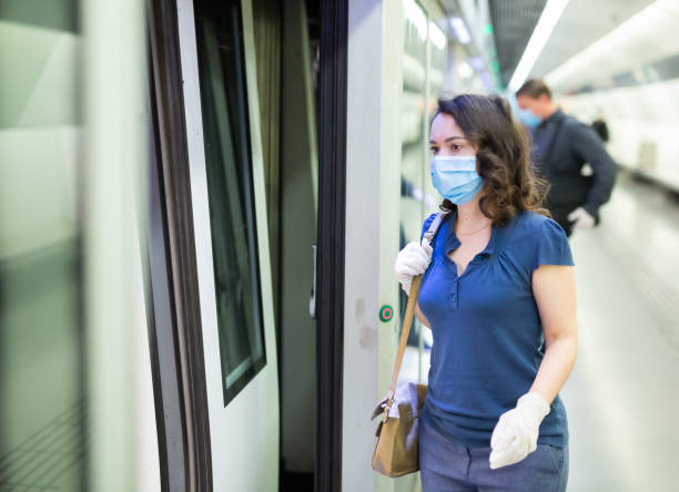 istock Woman in personal protective equipment is standing on platform metro 1225655901