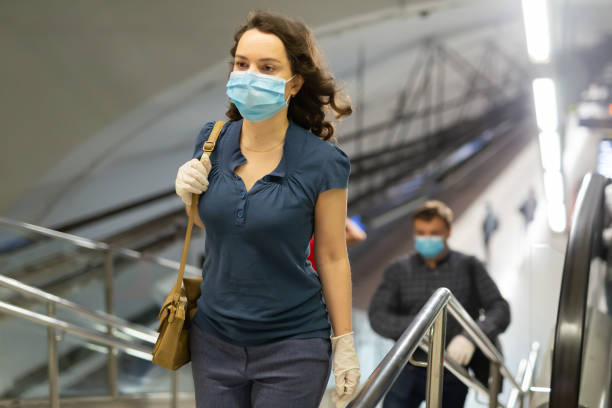 istock Woman in disposable mask climbing stairs 1225655904