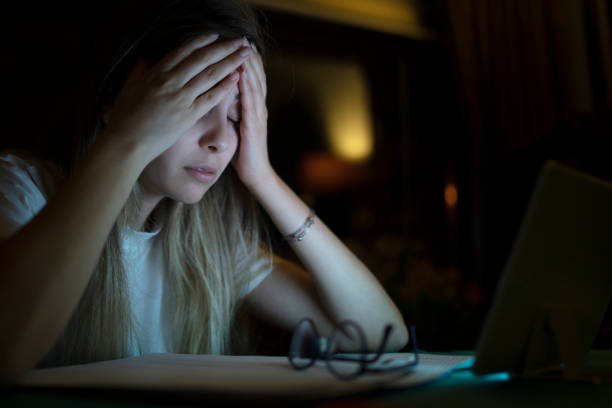 istock young business woman has a headache while working at night 1225655918