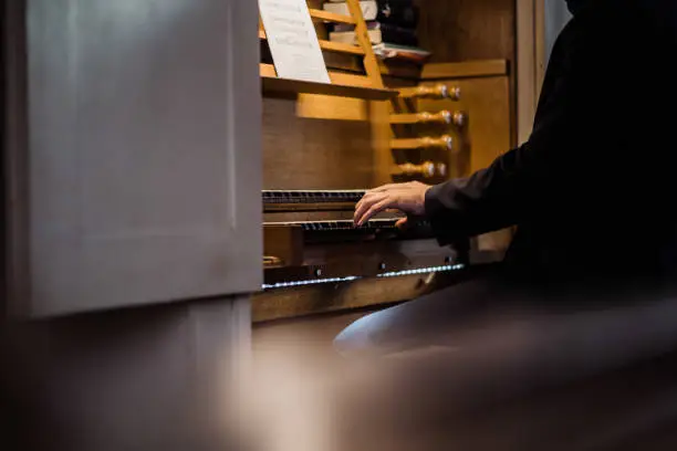 a man playing piano in a church