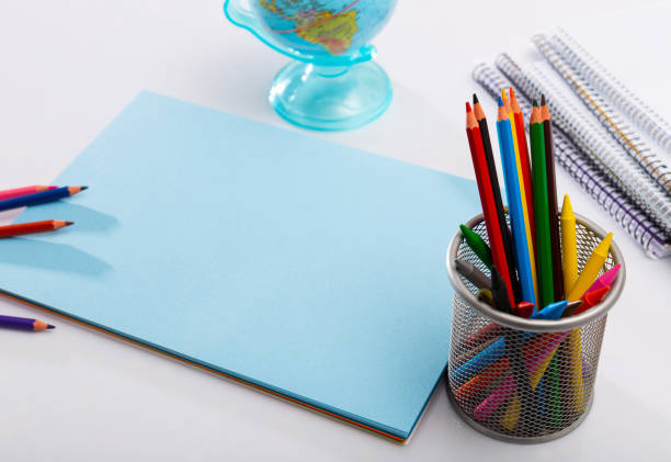 istock Blue sheet of paper and pencils 1225656104