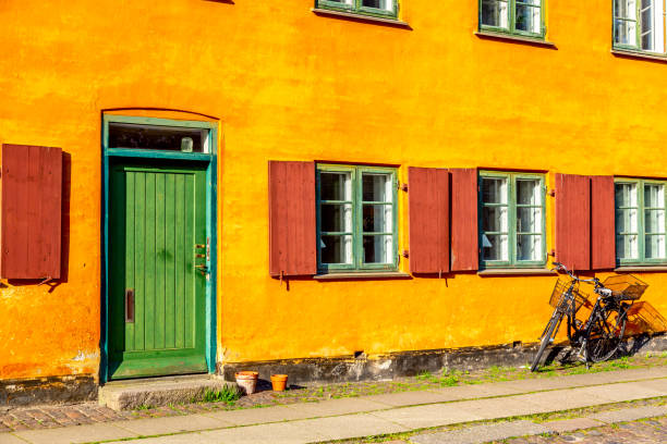 istock Old yellow house of Nyboder district with a bicycle. Old Medieval district in Copenhagen, Denmark 1225662543