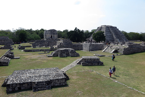 Mayapan, Yucatan, Mexico - Jan. 28, 2020:  Visitors walk through the grounds of the Mayan ruins at Mayapan, 35 miles southeast of Merida.  Mayapan was the Mayan capital of the Yucatan peninsula from approximately 1200 A.D. to 1400 A.D.