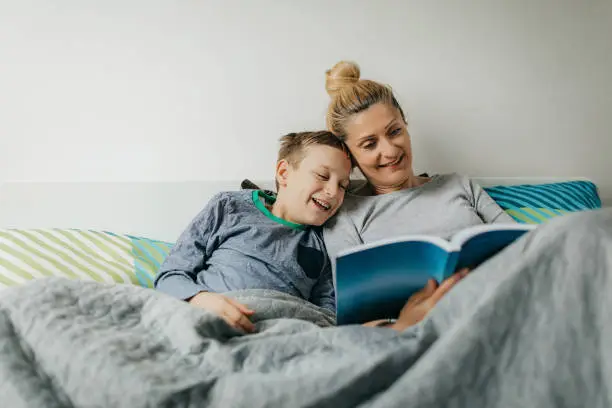 Photo of Mother and son in bedroom spend some quality time